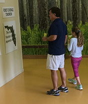 Father_Daughter_Looking_at_Display.gif